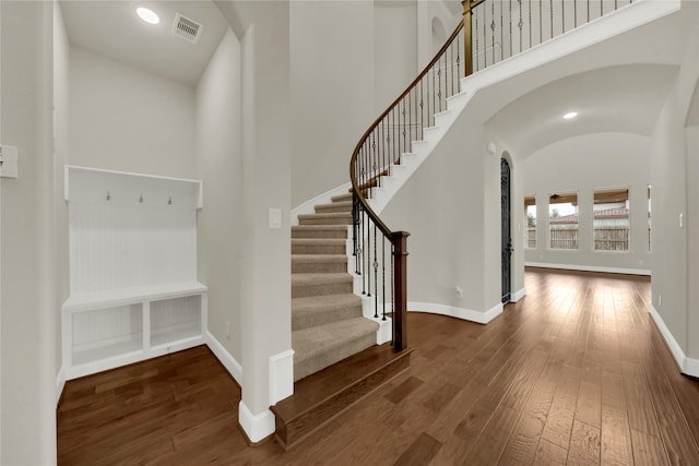 entryway with lofted ceiling and dark hardwood / wood-style flooring