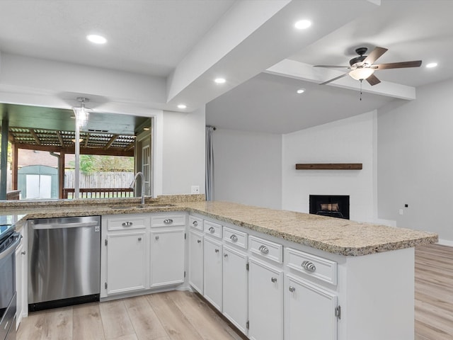 kitchen with sink, white cabinets, light hardwood / wood-style floors, kitchen peninsula, and stainless steel dishwasher