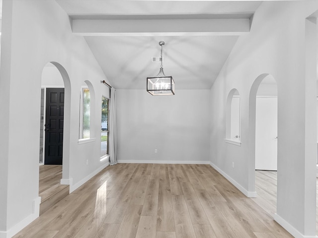 unfurnished dining area featuring a notable chandelier, lofted ceiling with beams, and light wood-type flooring