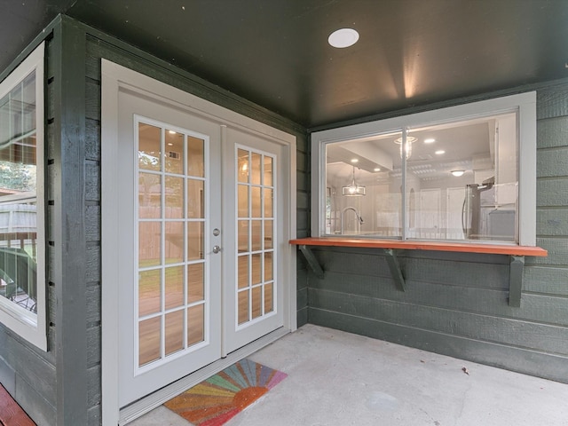 doorway to outside with french doors and concrete flooring