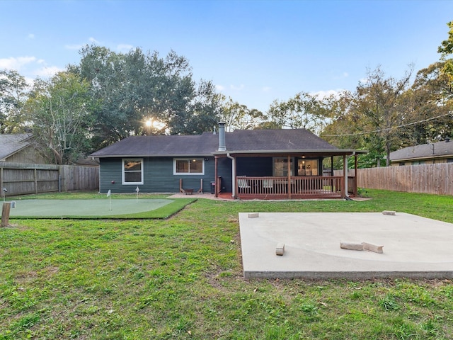 rear view of property featuring a patio area and a lawn