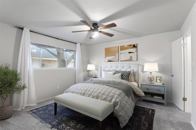 carpeted bedroom with ceiling fan and a textured ceiling