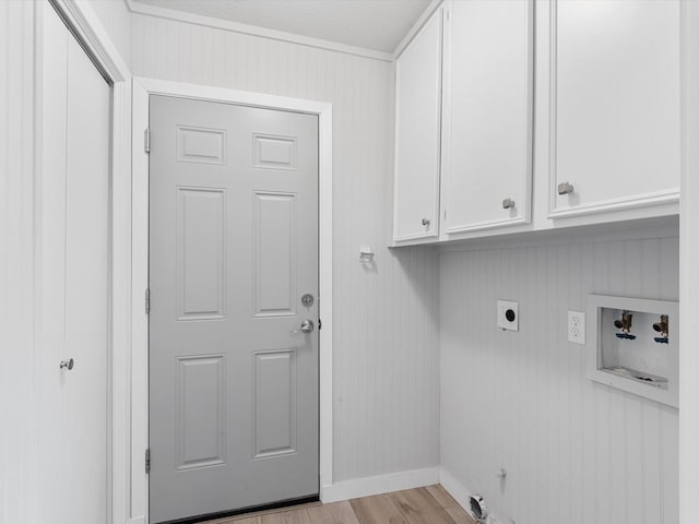 laundry room featuring light hardwood / wood-style floors, hookup for a washing machine, cabinets, and hookup for an electric dryer