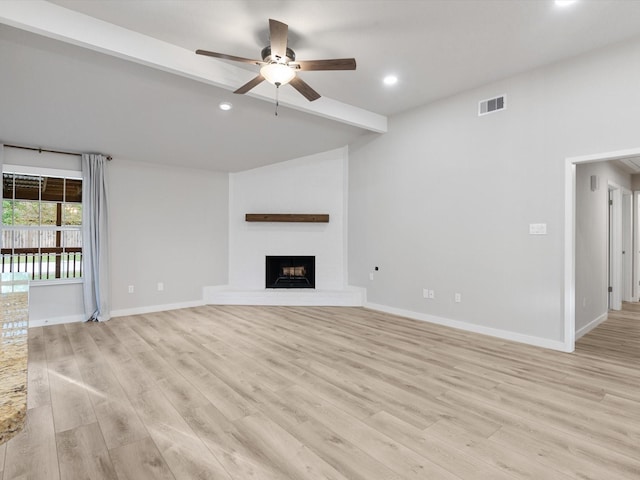 unfurnished living room featuring ceiling fan and light wood-type flooring