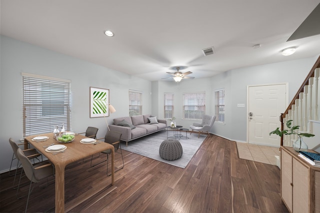 living room featuring ceiling fan and dark wood-type flooring