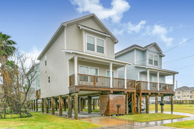 beach home with a carport, a front yard, and covered porch