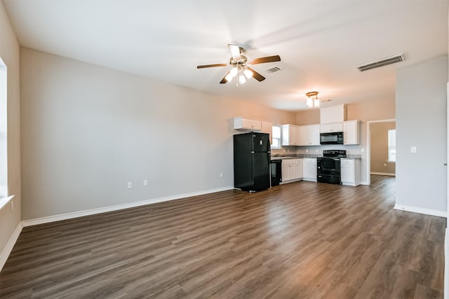 unfurnished living room featuring ceiling fan and dark hardwood / wood-style floors