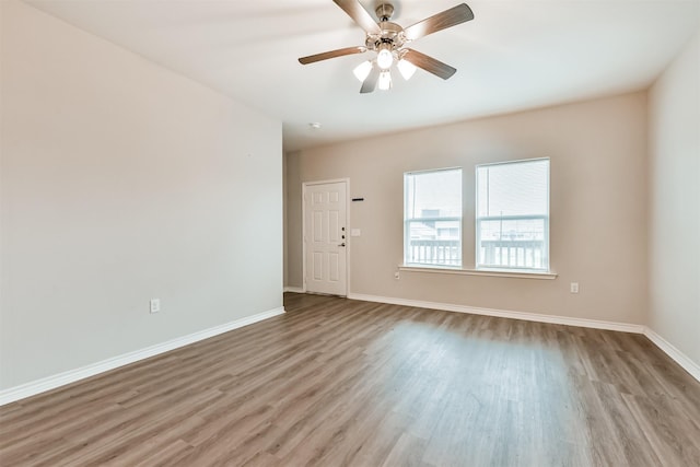 unfurnished room featuring light wood-type flooring and ceiling fan