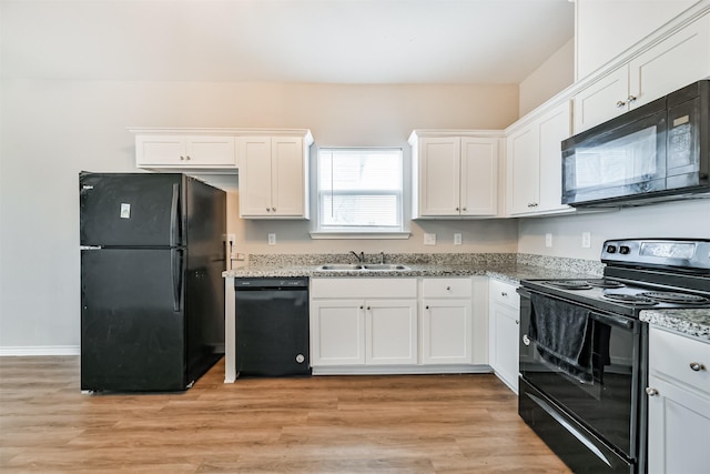 kitchen featuring light hardwood / wood-style flooring, white cabinets, black appliances, and sink