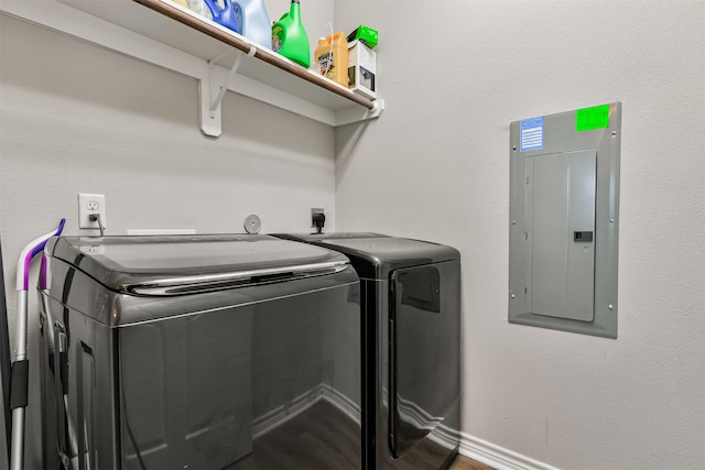 laundry room with electric panel and washer and dryer