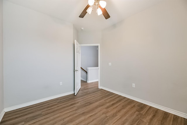 unfurnished bedroom with ceiling fan and dark hardwood / wood-style floors