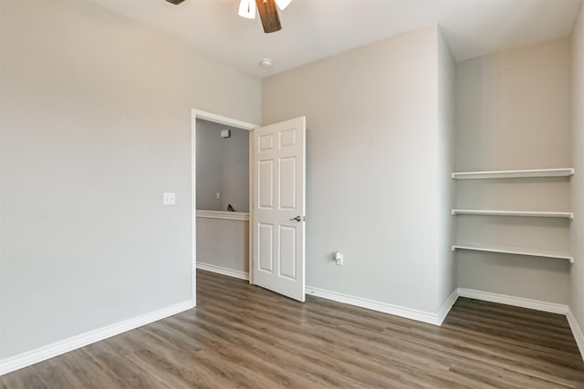 empty room with ceiling fan and wood-type flooring