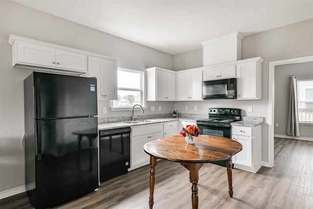 kitchen featuring black appliances, sink, and white cabinetry