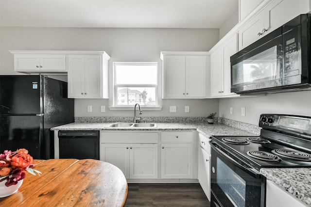 kitchen featuring light stone countertops, sink, white cabinetry, and black appliances