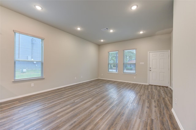 unfurnished room featuring plenty of natural light and hardwood / wood-style flooring