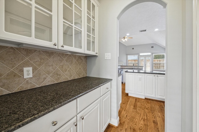 kitchen featuring lofted ceiling, ceiling fan, light hardwood / wood-style floors, and white cabinetry