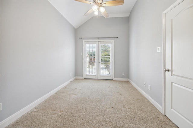 carpeted empty room with ceiling fan, french doors, and lofted ceiling