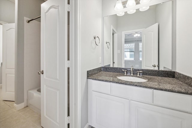 bathroom featuring vanity, tile patterned floors, ceiling fan, and bathing tub / shower combination