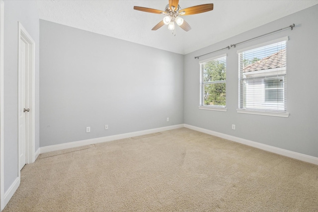 carpeted empty room featuring ceiling fan