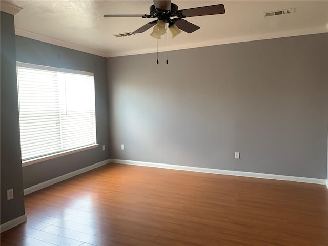 spare room featuring ornamental molding, ceiling fan, and hardwood / wood-style floors