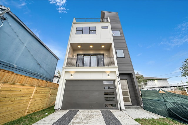 contemporary home featuring a garage and a balcony