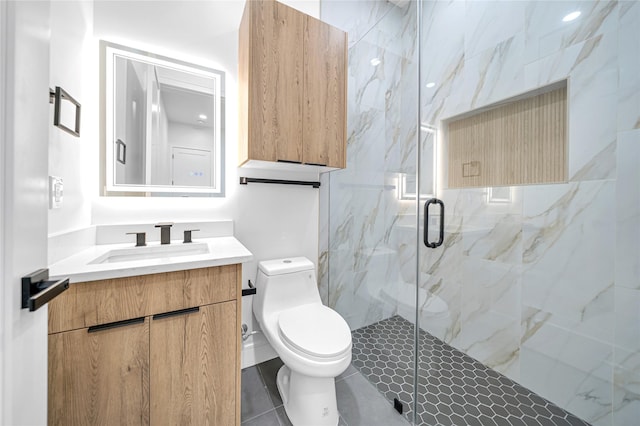 bathroom featuring toilet, tile patterned floors, walk in shower, and vanity