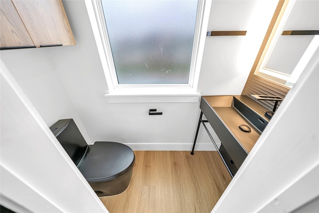 bathroom featuring toilet and hardwood / wood-style floors