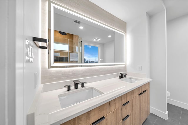 bathroom featuring toilet, vanity, tile patterned floors, decorative backsplash, and a shower with shower door