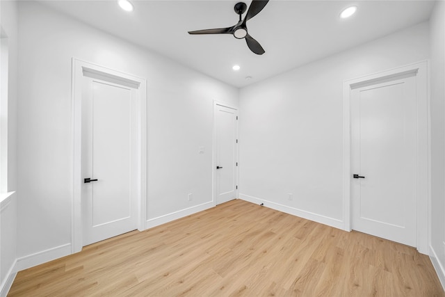 empty room featuring light wood-type flooring and ceiling fan