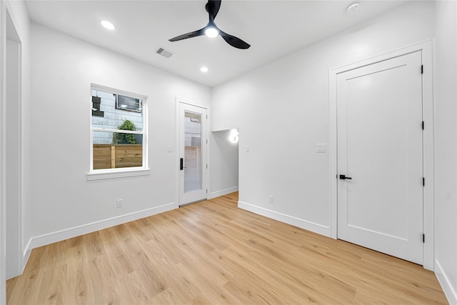 empty room featuring light wood-type flooring and ceiling fan