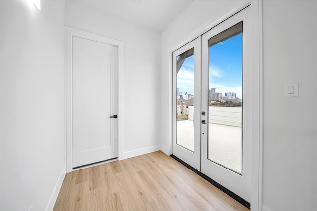 doorway with light hardwood / wood-style flooring and french doors