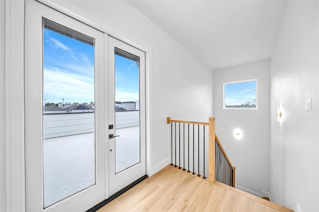 doorway with light hardwood / wood-style floors and french doors