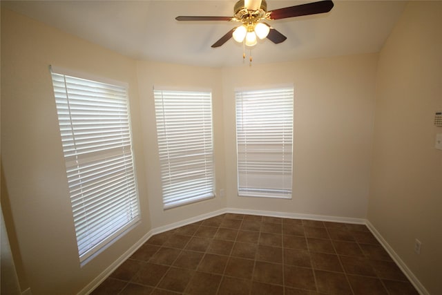 tiled empty room with ceiling fan