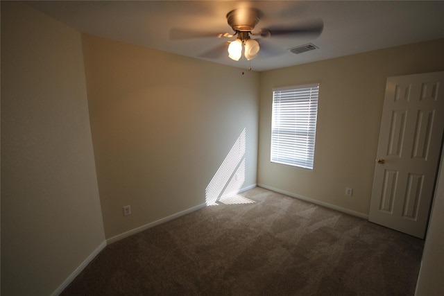 carpeted spare room with ceiling fan