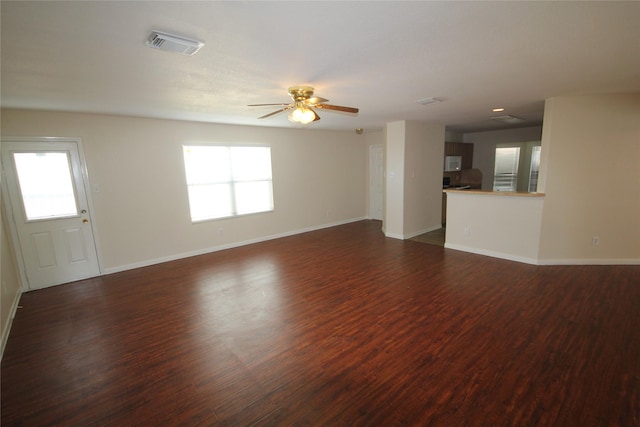 unfurnished living room with ceiling fan and dark hardwood / wood-style floors