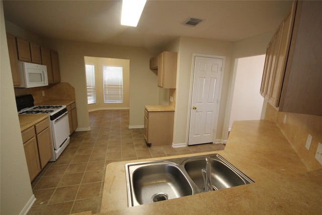 kitchen with sink, white appliances, and tasteful backsplash