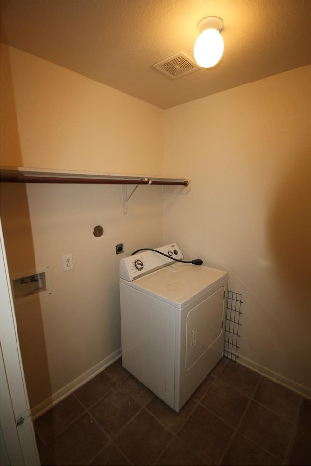 laundry room featuring washer / clothes dryer and dark tile patterned floors