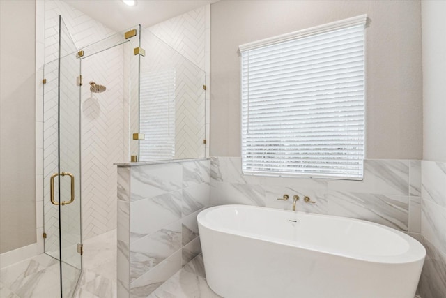 bathroom with tile walls, a healthy amount of sunlight, and plus walk in shower