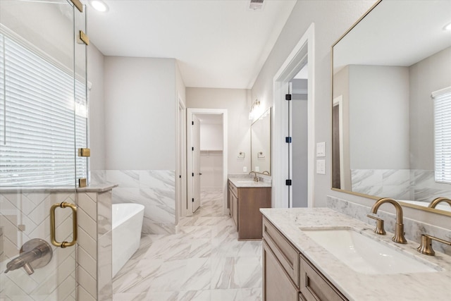 bathroom with vanity, plenty of natural light, and a bathing tub