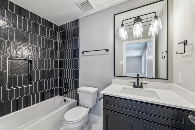 full bathroom with toilet, tiled shower / bath, vanity, and a textured ceiling