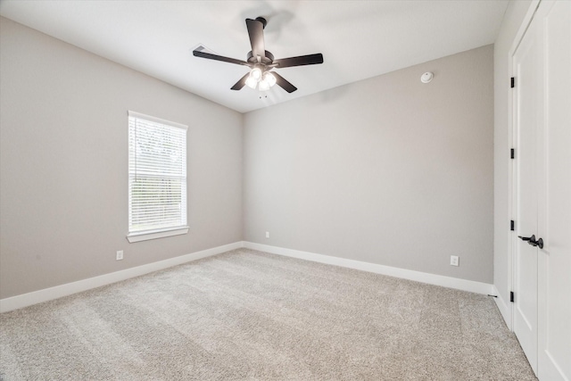 empty room with ceiling fan and light colored carpet