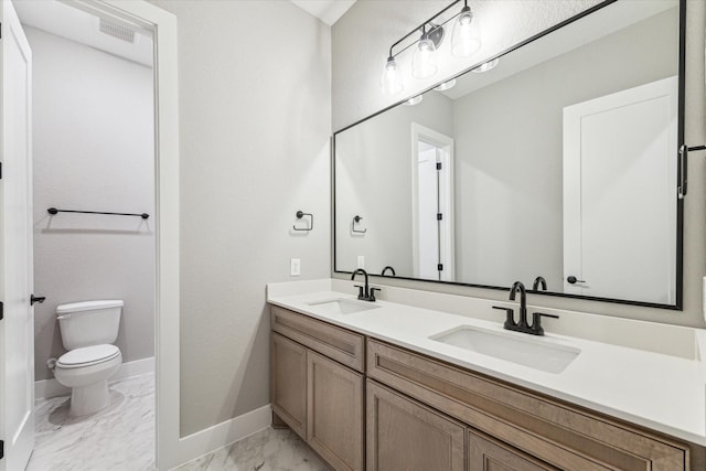 bathroom with toilet and vanity