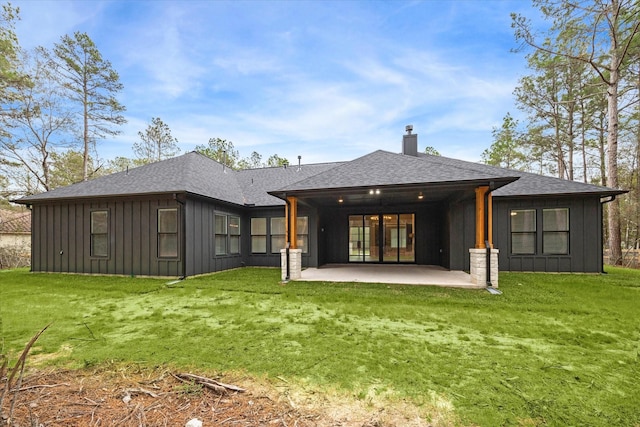 rear view of house featuring a patio area and a yard