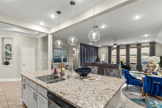 kitchen with sink, white cabinetry, ceiling fan, an island with sink, and hanging light fixtures