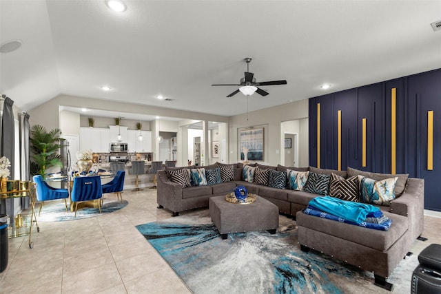 living room with ceiling fan and light tile patterned flooring