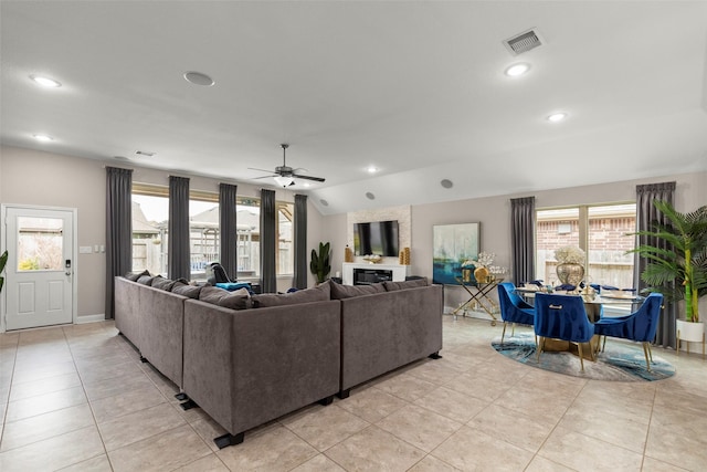 tiled living room featuring vaulted ceiling and ceiling fan