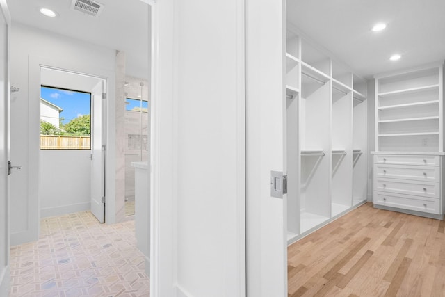 spacious closet featuring light hardwood / wood-style floors