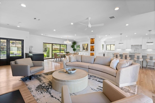 5658 Del Monte Dr, Houston, TX 77056 - living room with recessed lighting, light wood-style floors, a ceiling fan, and a chandelier