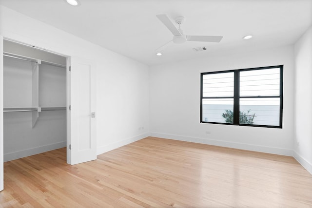 unfurnished bedroom with a closet, ceiling fan, and light wood-type flooring