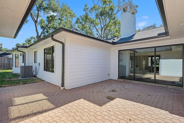 back of house featuring central air condition unit and a patio area